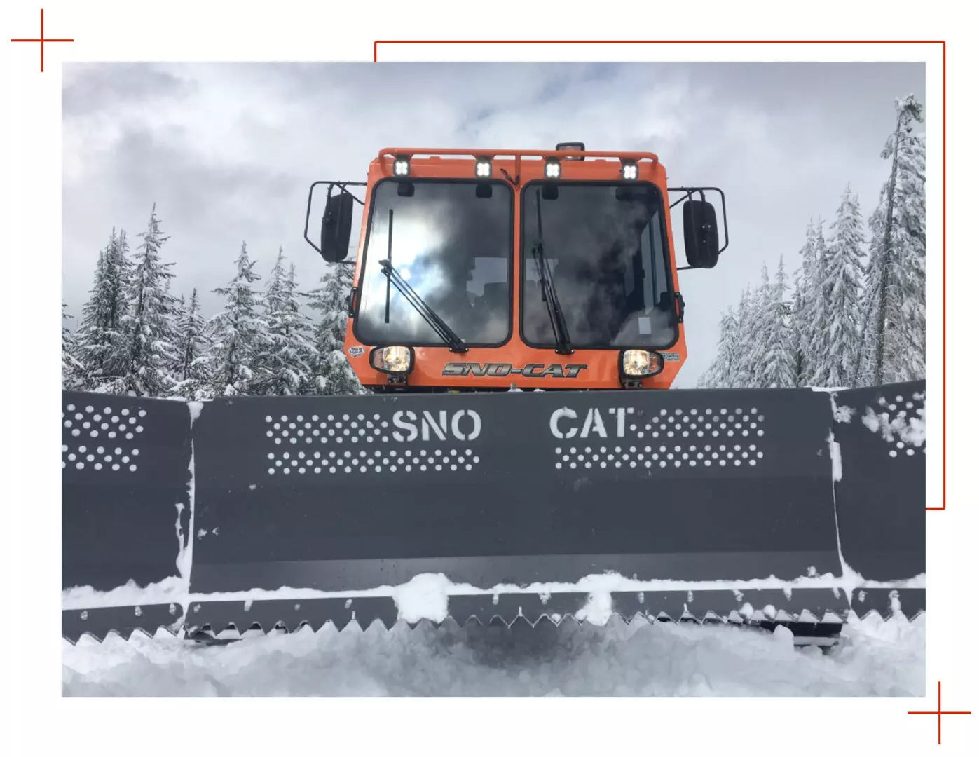 A snow cat is driving down the road.