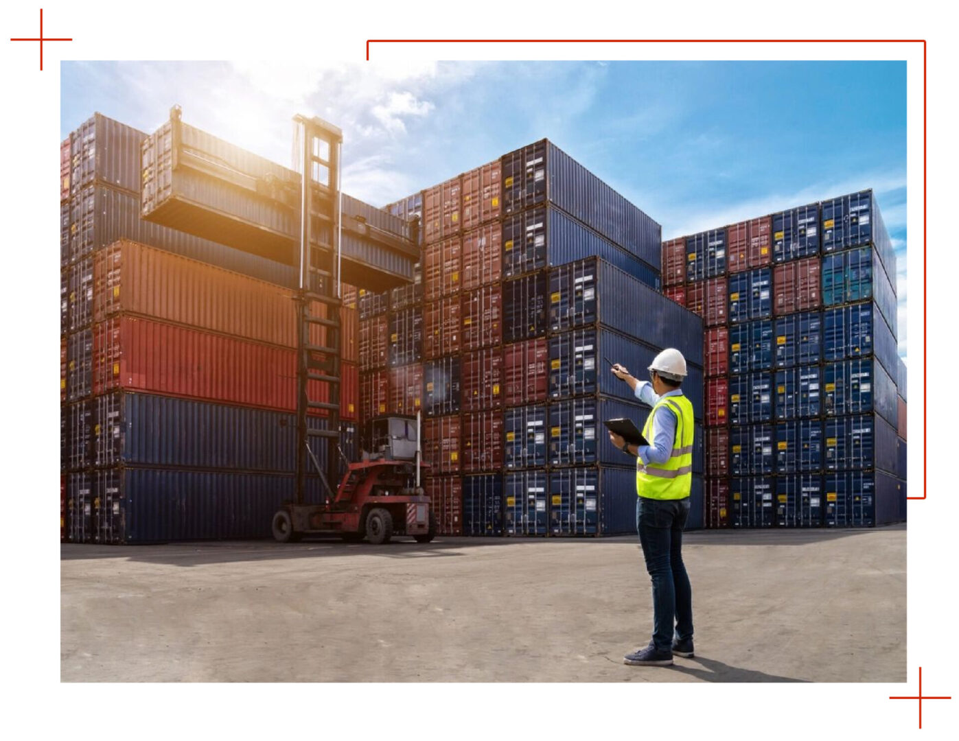 A man standing in front of stacks of shipping containers.